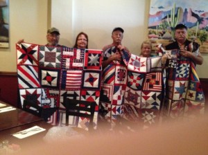 Veterans and their wives receiving their quilts